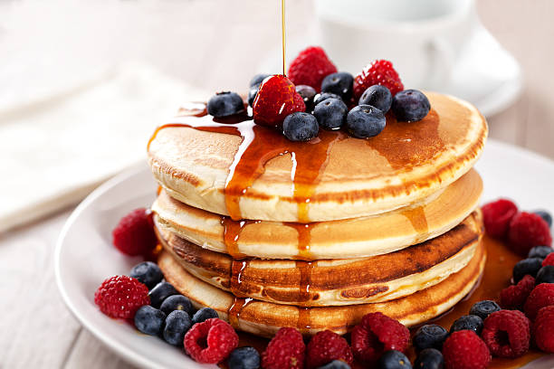 Pancakes with berries and maple syrup