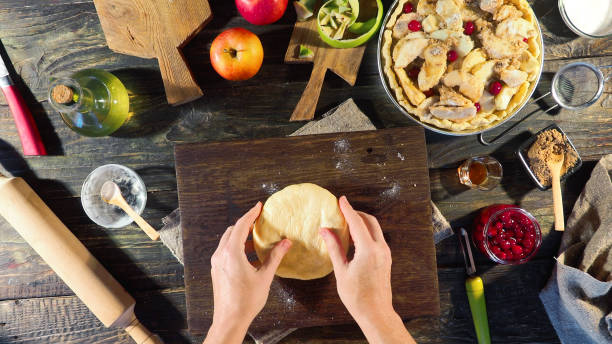 Making old fashioned Thanksgiving apple pie with cranberries. Preparing upper crust. Overhead view